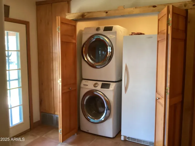 a view of a hallway with washer and dryer