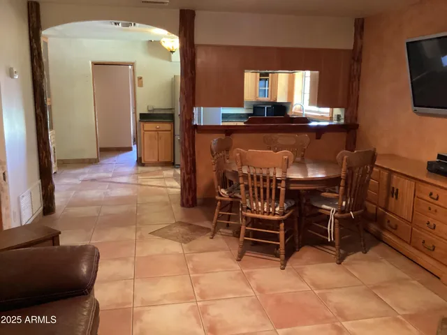 a dining room with furniture and a flat screen tv