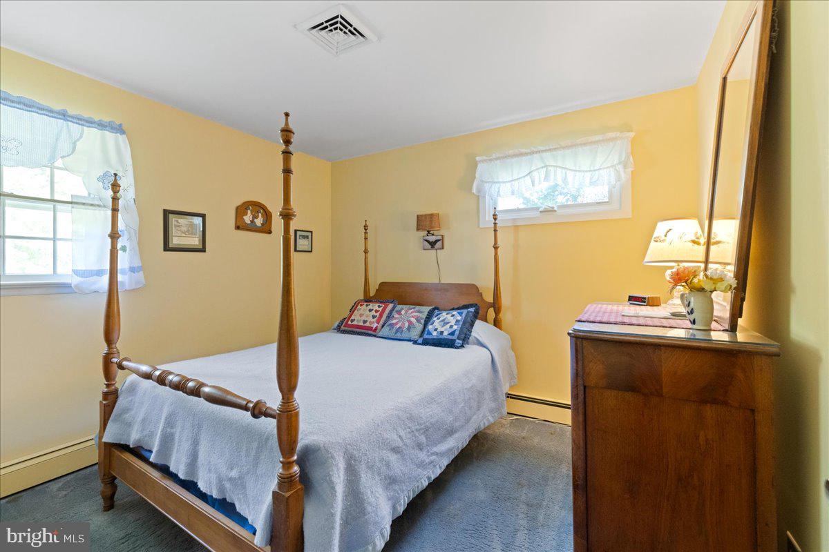 1714 Moyers Road Hatfield, PA 19440 - Photo 18 of 31 a bedroom with a bed and wooden floor