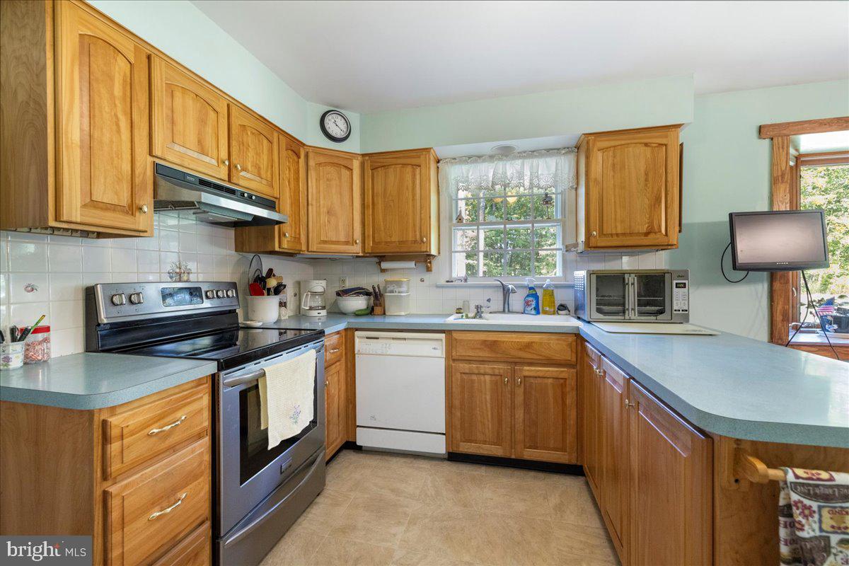 1714 Moyers Road Hatfield, PA 19440 - Photo 8 of 31 a kitchen with stainless steel appliances granite countertop a sink stove and cabinets