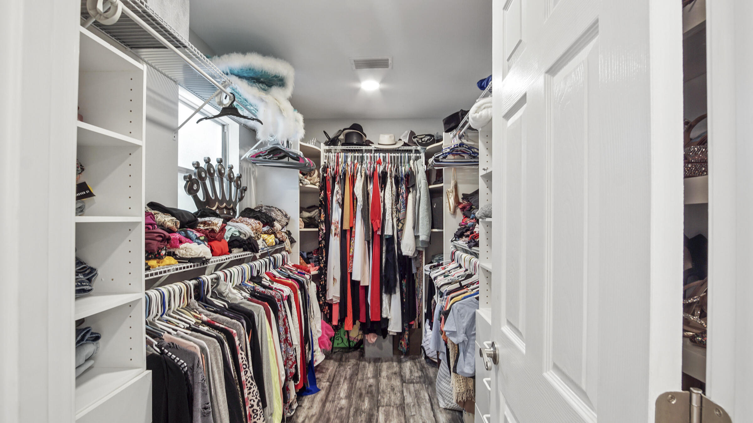 149 Acacia Street Santa Rosa Beach, FL 32459 - Photo 18 of 45 a view of walk in closet with clothes