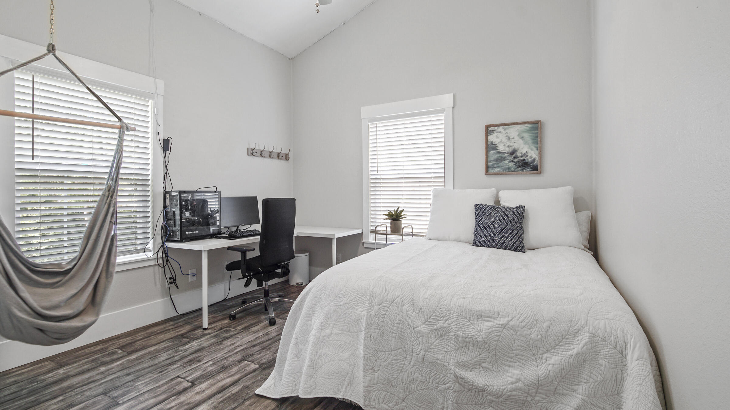 149 Acacia Street Santa Rosa Beach, FL 32459 - Photo 19 of 45 a bedroom with a bed a chair and a window