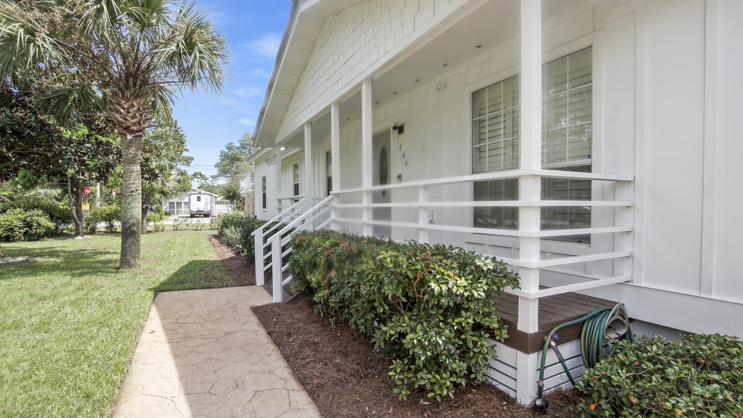 149 Acacia Street Santa Rosa Beach, FL 32459 - Photo 2 of 45 front view of a building with a yard