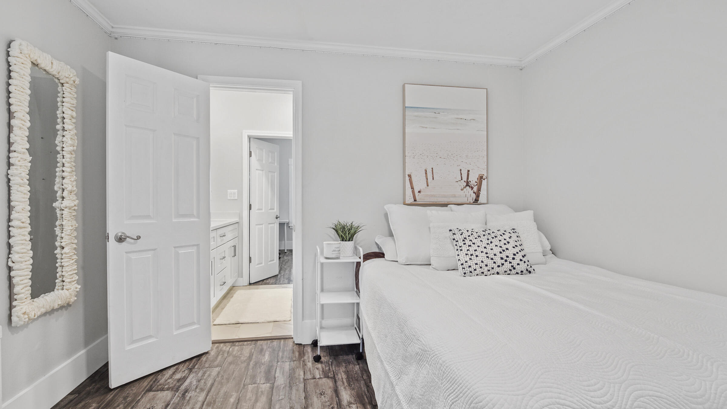 149 Acacia Street Santa Rosa Beach, FL 32459 - Photo 25 of 45 a bedroom with a bed and wooden floor