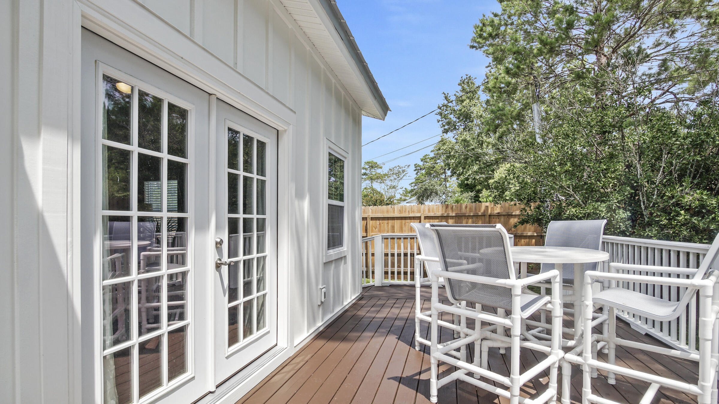 149 Acacia Street Santa Rosa Beach, FL 32459 - Photo 32 of 45 a view of a roof deck with table and chairs and wooden floor