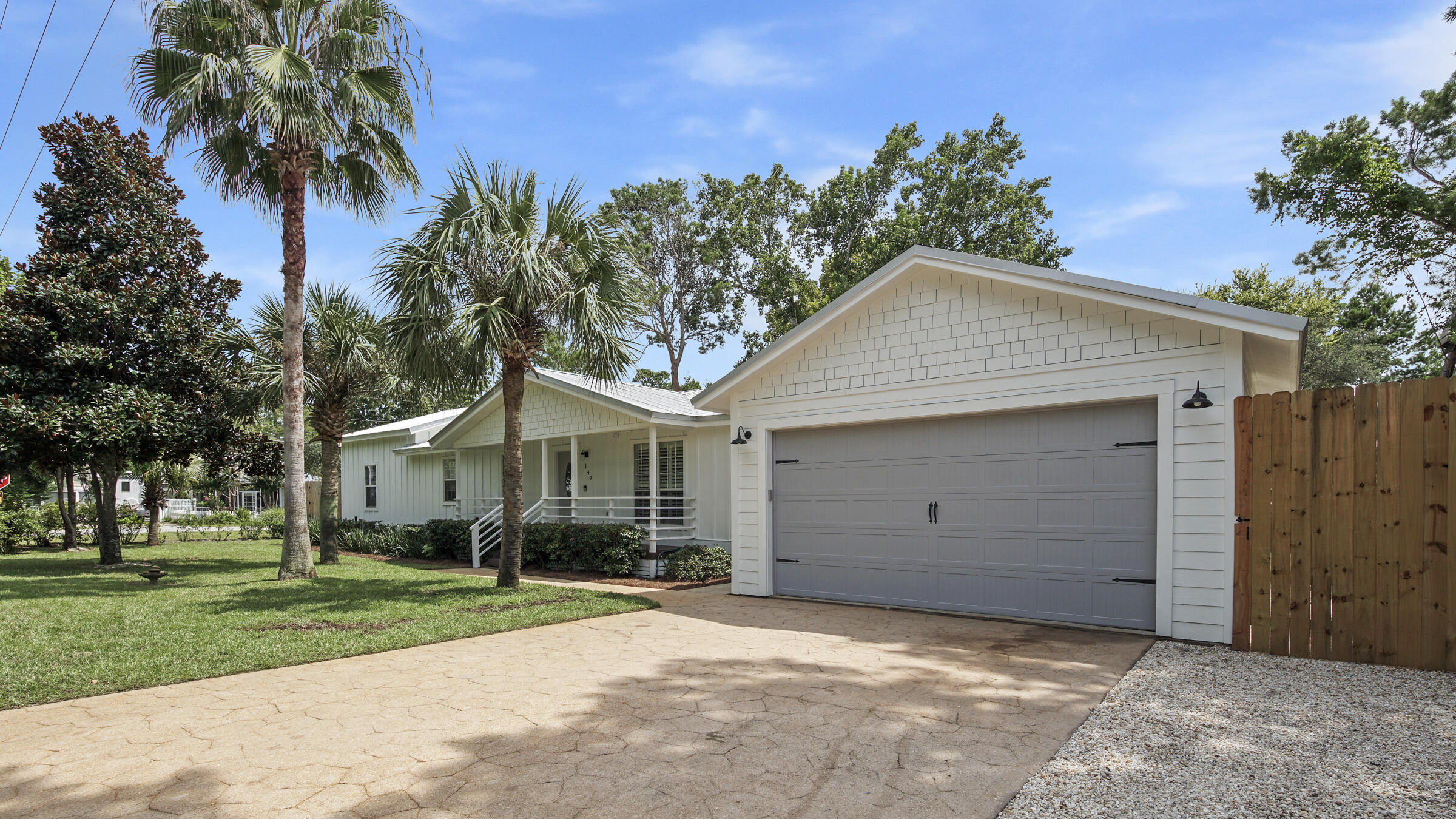 149 Acacia Street Santa Rosa Beach, FL 32459 - Photo 39 of 45 front view of a house with a yard and palm trees