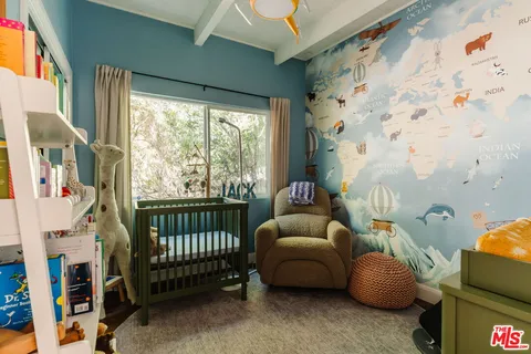 a bedroom with furniture and a window
