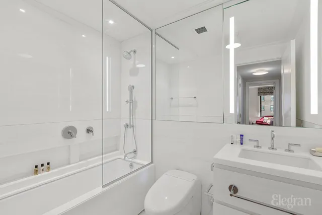 a kitchen with a sink a microwave and cabinets