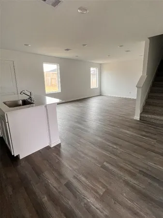 a view of hallway with wooden floor