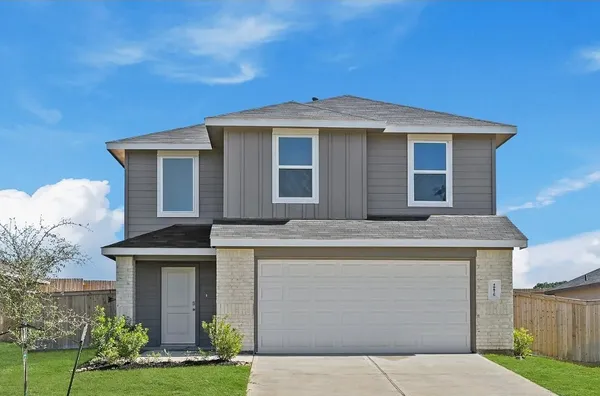 a front view of a house with a yard garage and outdoor seating