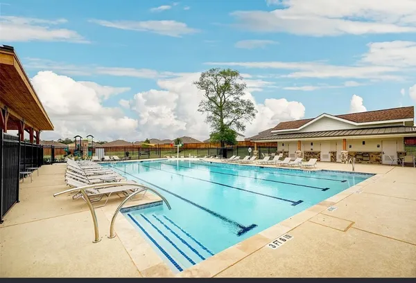 a view of swimming pool with outdoor seating