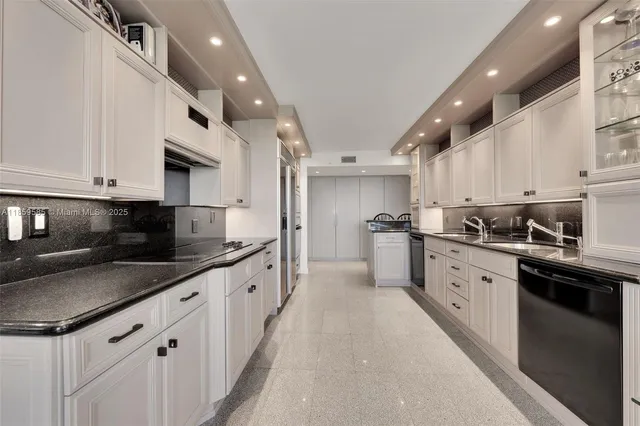 a large kitchen with stainless steel appliances lots of counter space sink and cabinets