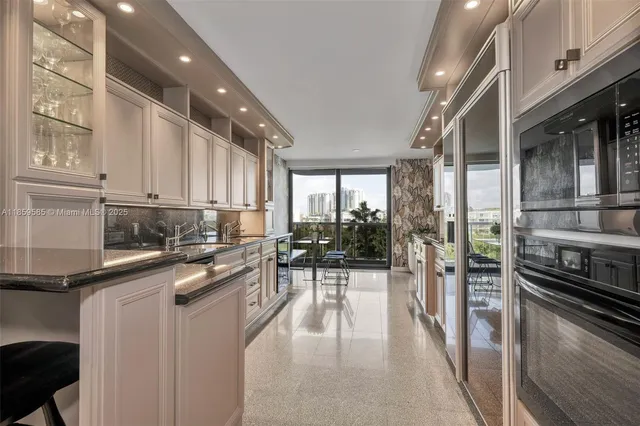 a kitchen with a sink appliances and cabinets