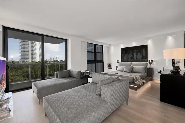 a living room with furniture large window and a wooden floor