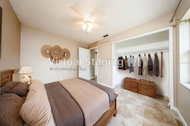 a spacious bedroom with a bed and couch