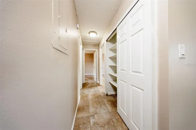 a view of a hallway with wooden floor and entryway