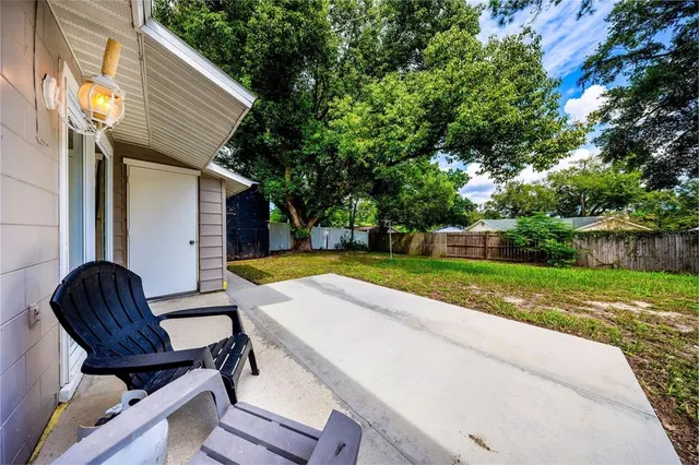 a view of backyard with swimming pool and outdoor seating