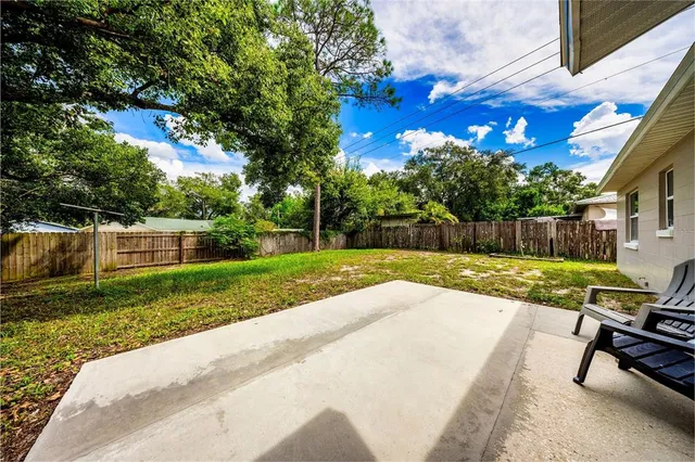 a view of a backyard with sitting area