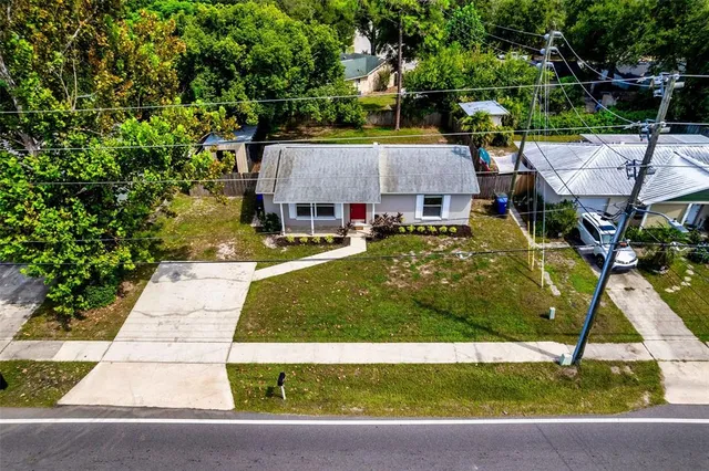 a view of backyard with swimming pool and seating space