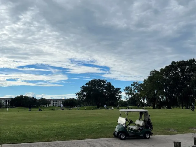 a car parked in the grass near a building