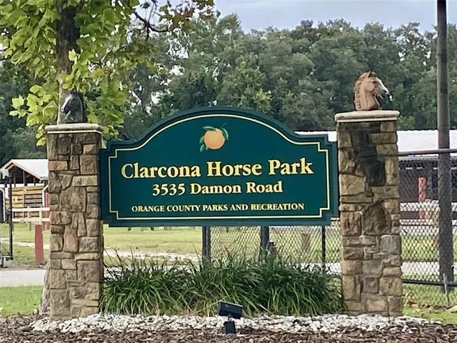 a view of a yard with table and chairs in the patio