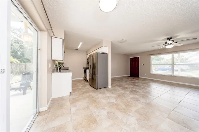 a view of a big room with windows and entryway
