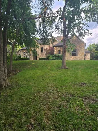 a yellow house in middle of the forest
