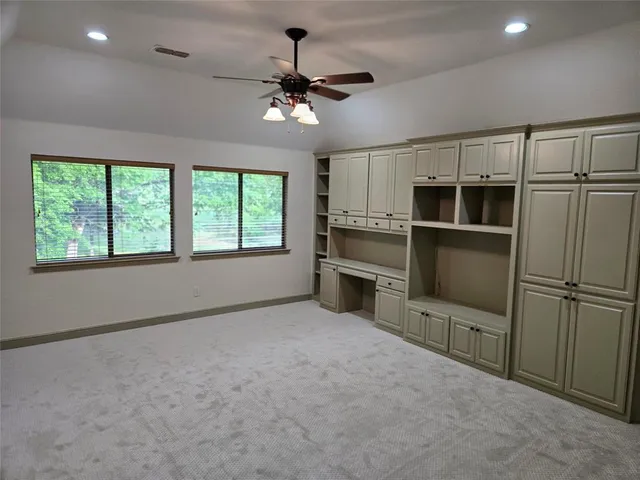a view of a kitchen with a stove cabinets and stainless steel appliances