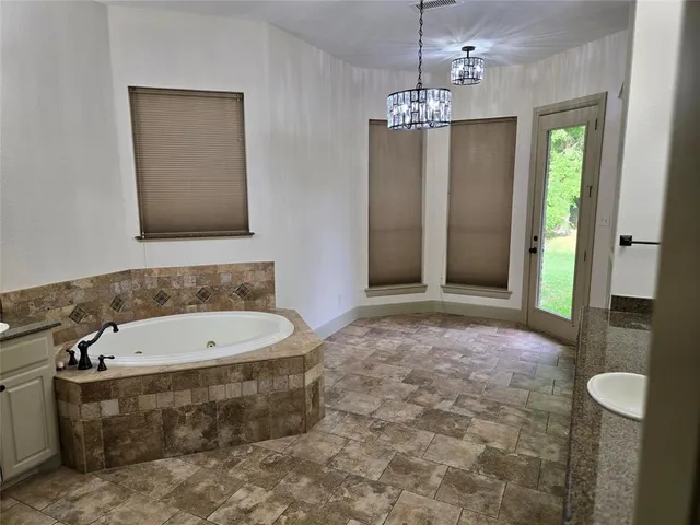 a bathroom with a bathtub and shower