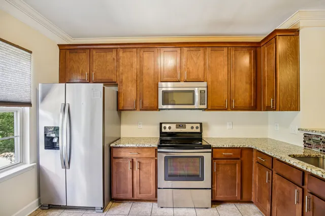 a kitchen with a refrigerator stove and sink