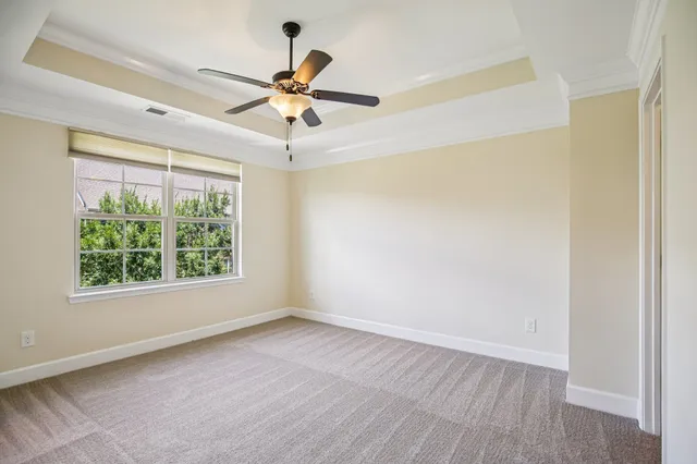 a view of a big room with wooden floor closet and windows in a room