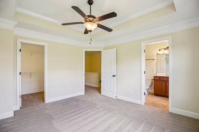 a view of a livingroom with a ceiling fan and wooden floor