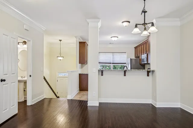 a view of a kitchen with wooden floor and a ceiling fan