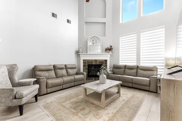 a living room with furniture and a fireplace