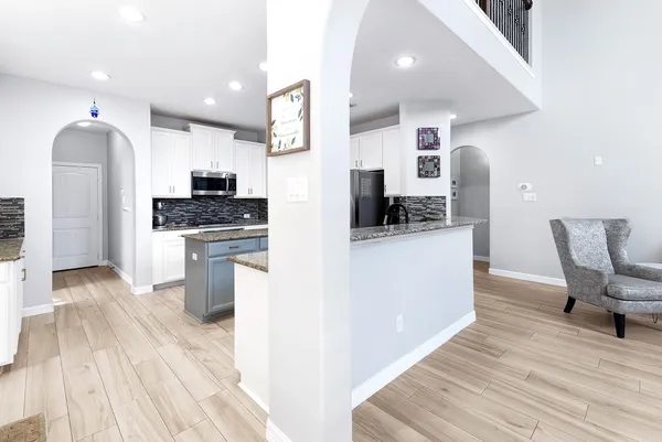 a kitchen with stainless steel appliances a stove top oven a sink dishwasher and a refrigerator