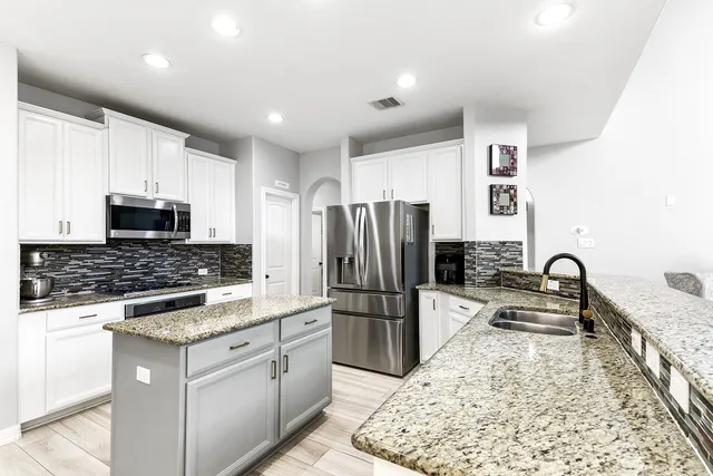 a kitchen with refrigerator and furniture