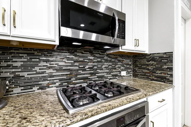 a kitchen with a stove and a microwave