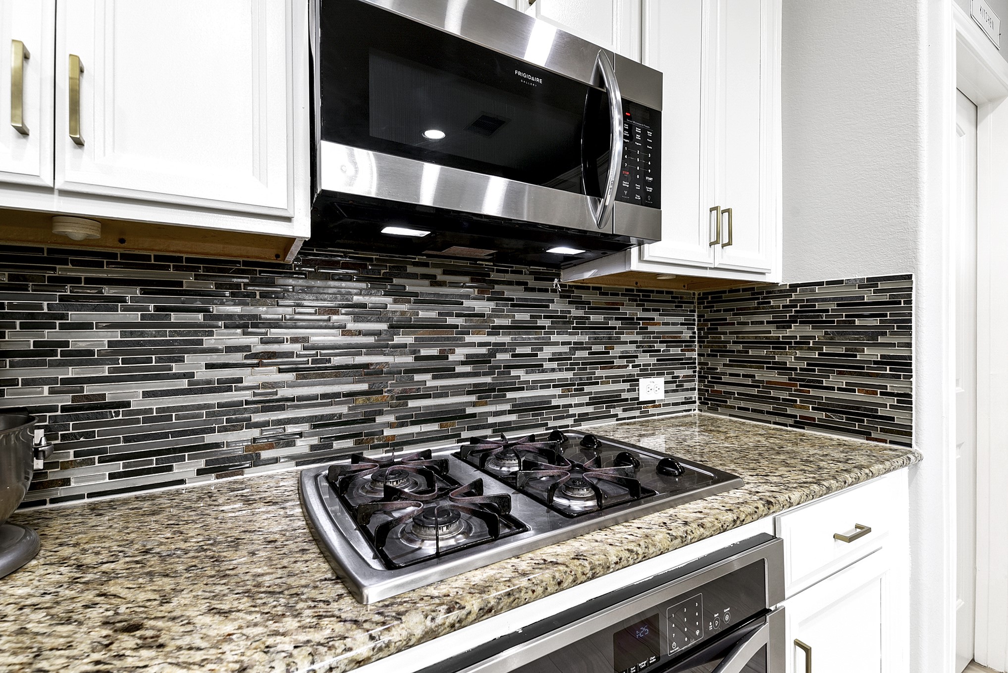 29022 Pinnacle Ridge Drive Katy, TX 77494 - Photo 18 of 45 a kitchen with a stove and a microwave