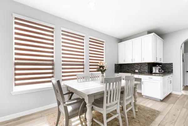 a kitchen with a table chairs and a window