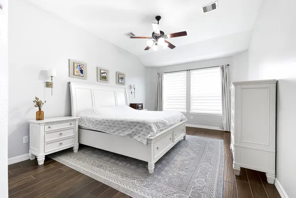 a bedroom with a large bed and a chandelier