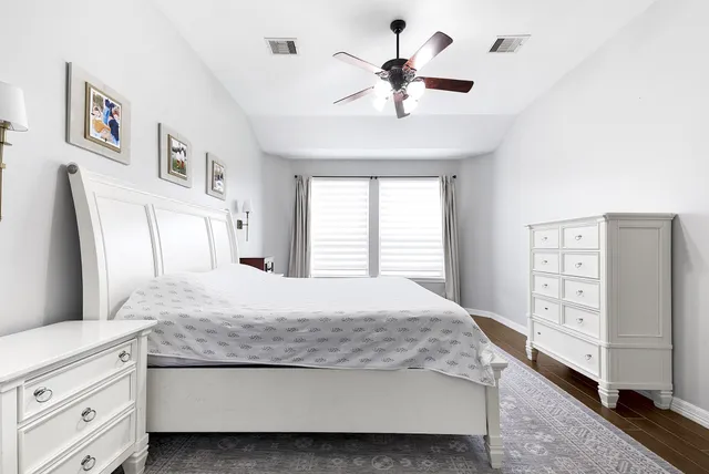 a bedroom with a large bed and a chandelier