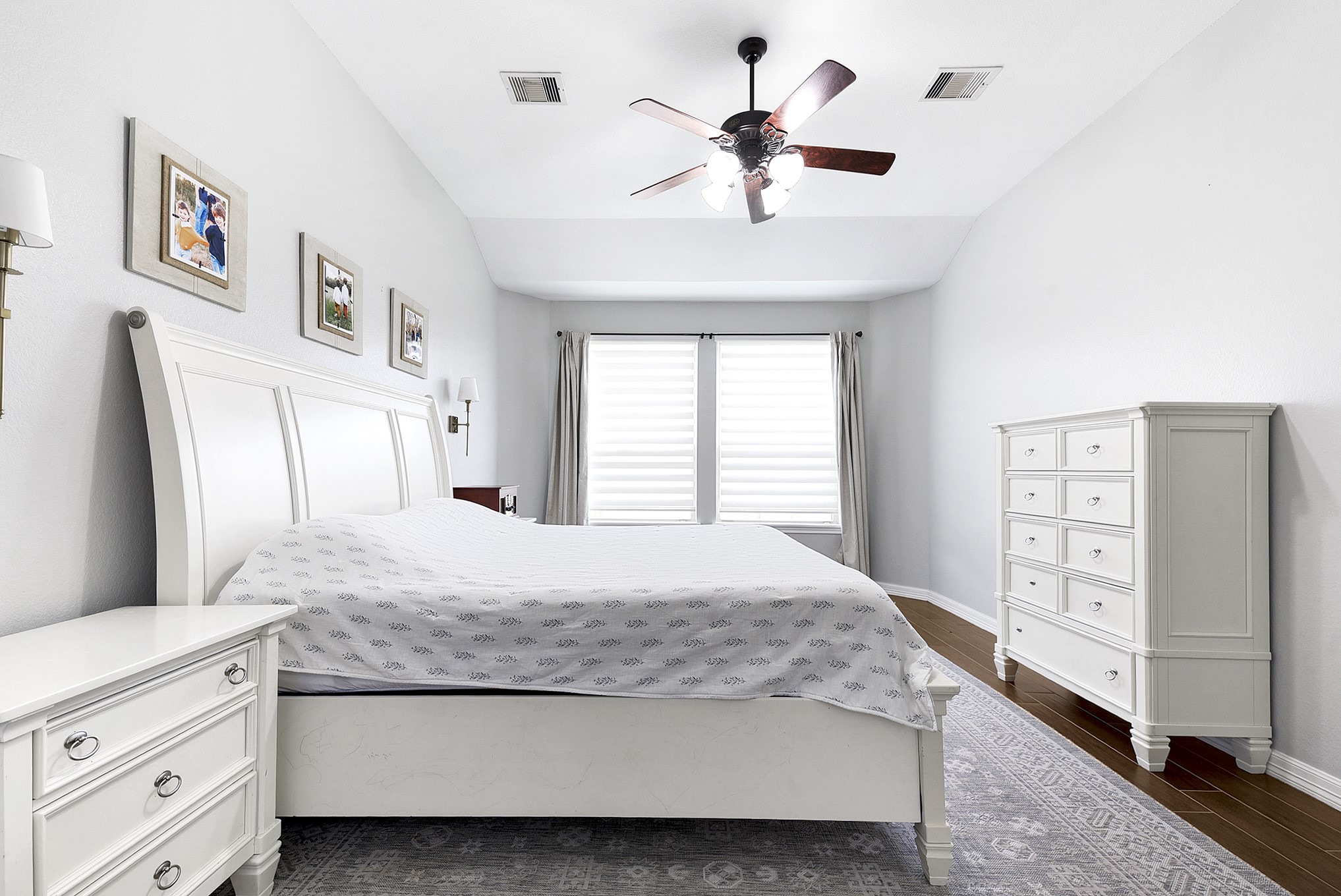 29022 Pinnacle Ridge Drive Katy, TX 77494 - Photo 26 of 45 a bedroom with a large bed and a chandelier