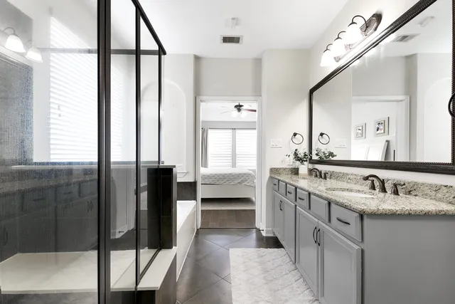 a bathroom with a double vanity sink and mirror