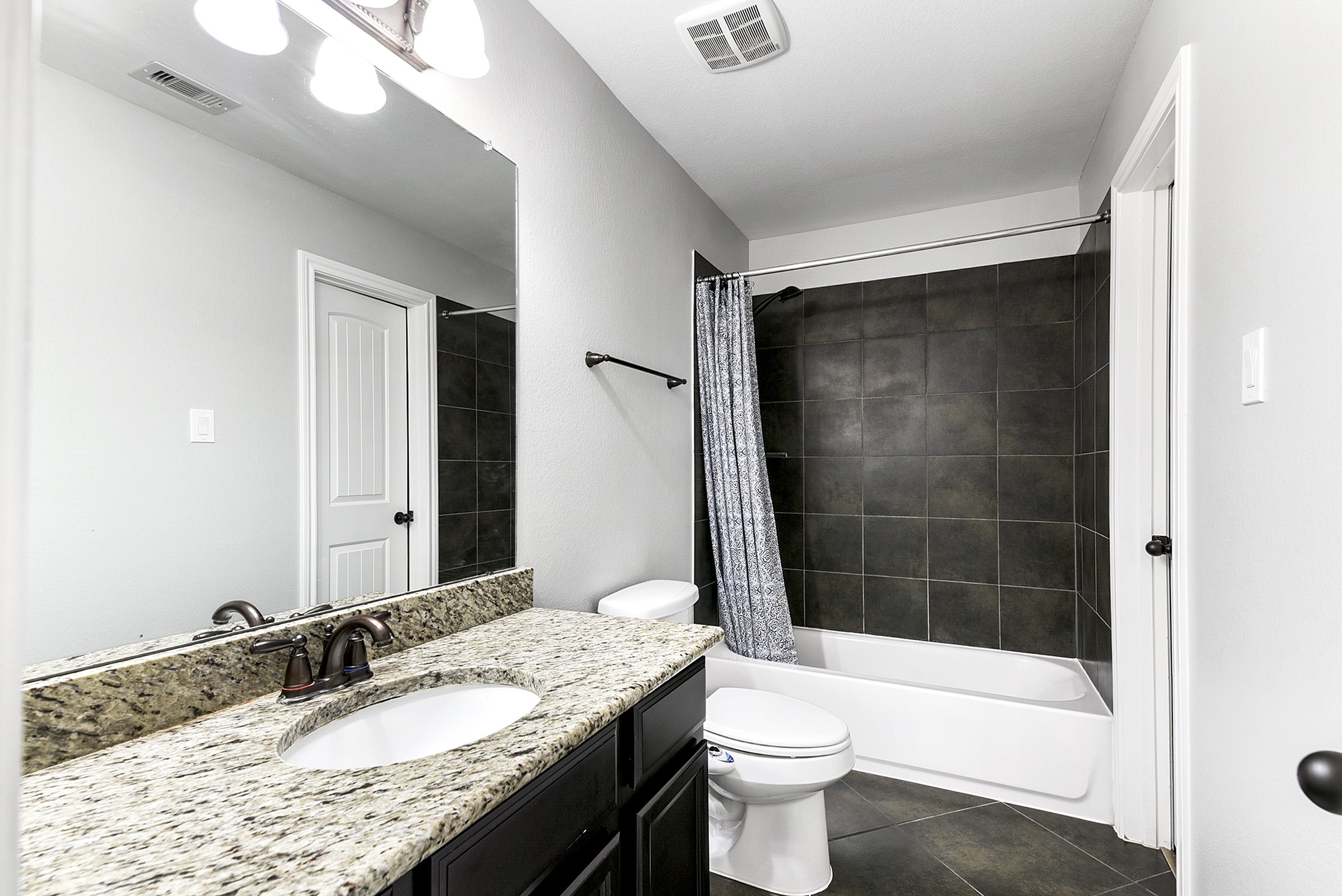 29022 Pinnacle Ridge Drive Katy, TX 77494 - Photo 34 of 45 a bathroom with a granite countertop sink toilet mirror and bathtub
