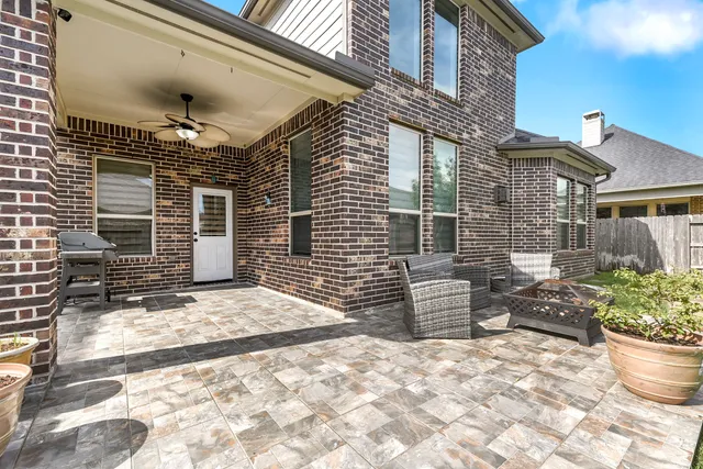 a view of a patio with a table and chairs and potted plants