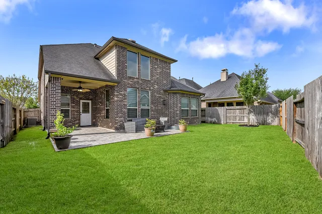 a backyard of a house with outdoor seating