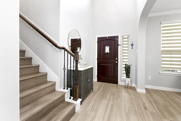 a view of entryway with wooden floor and stairs