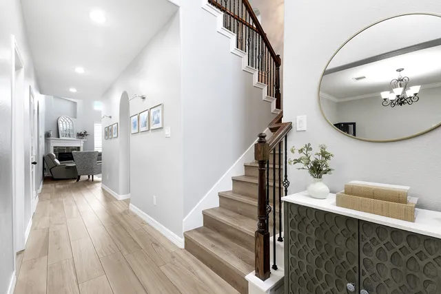 a view of entryway and hall with wooden floor