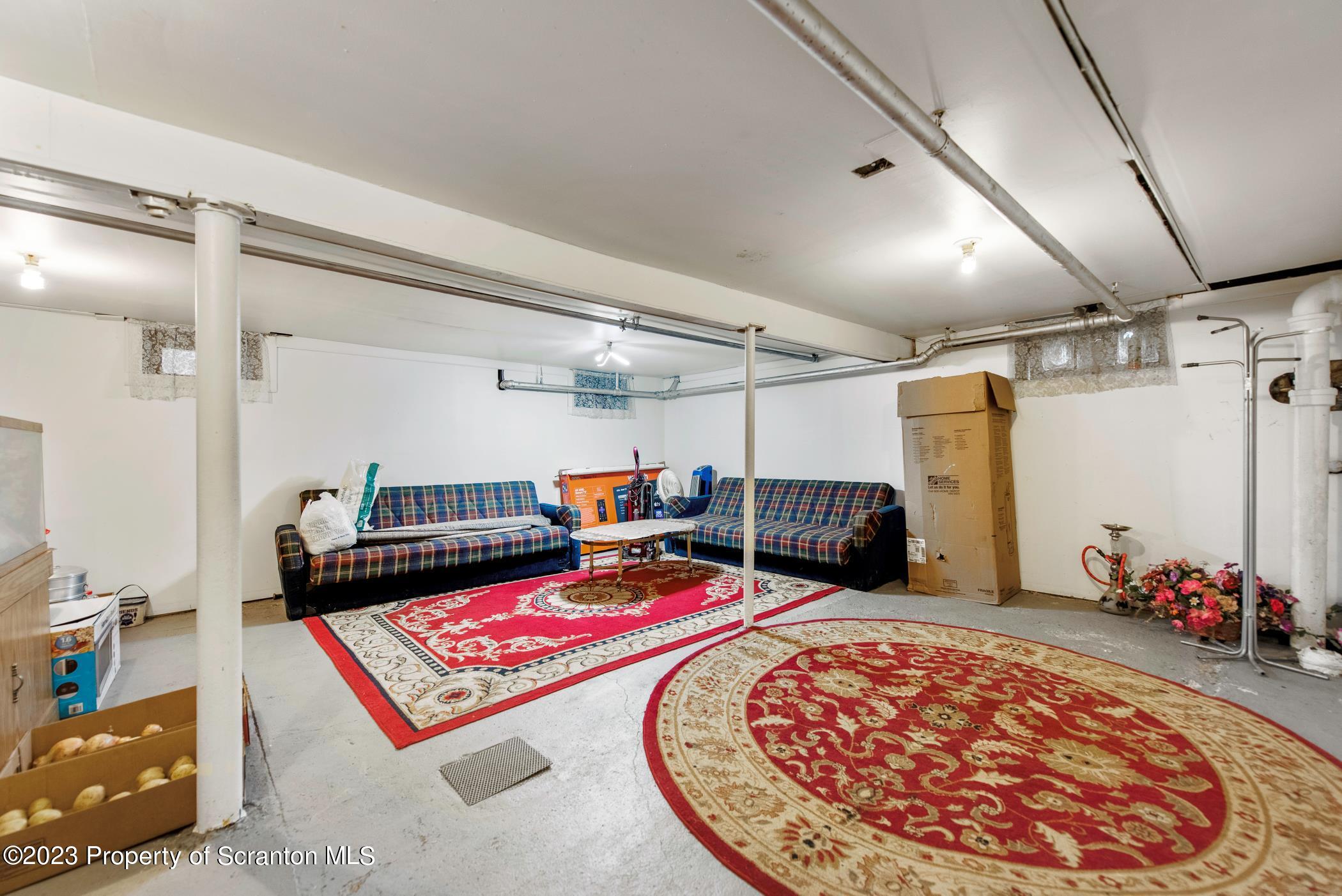 726 Hickory Street Scranton, PA 18505 - Photo 21 of 26 a room with lots of white furniture and clothes