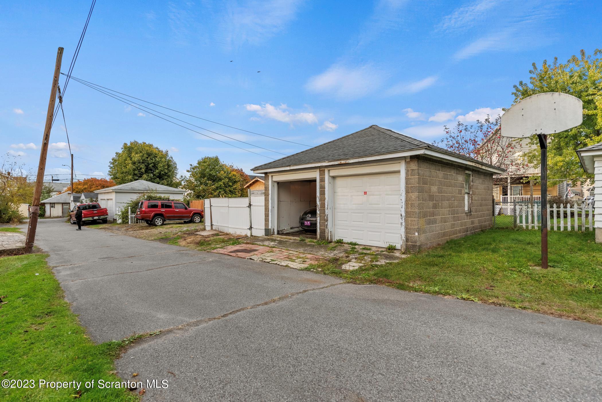 726 Hickory Street Scranton, PA 18505 - Photo 25 of 26 a car parked in front of a house with a yard